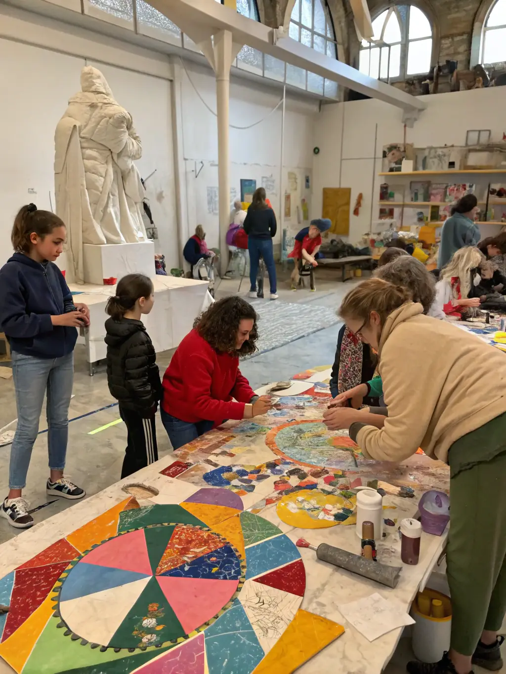 A vibrant photograph capturing a community art workshop in progress, with participants of diverse ages and backgrounds actively engaged in painting and crafting.